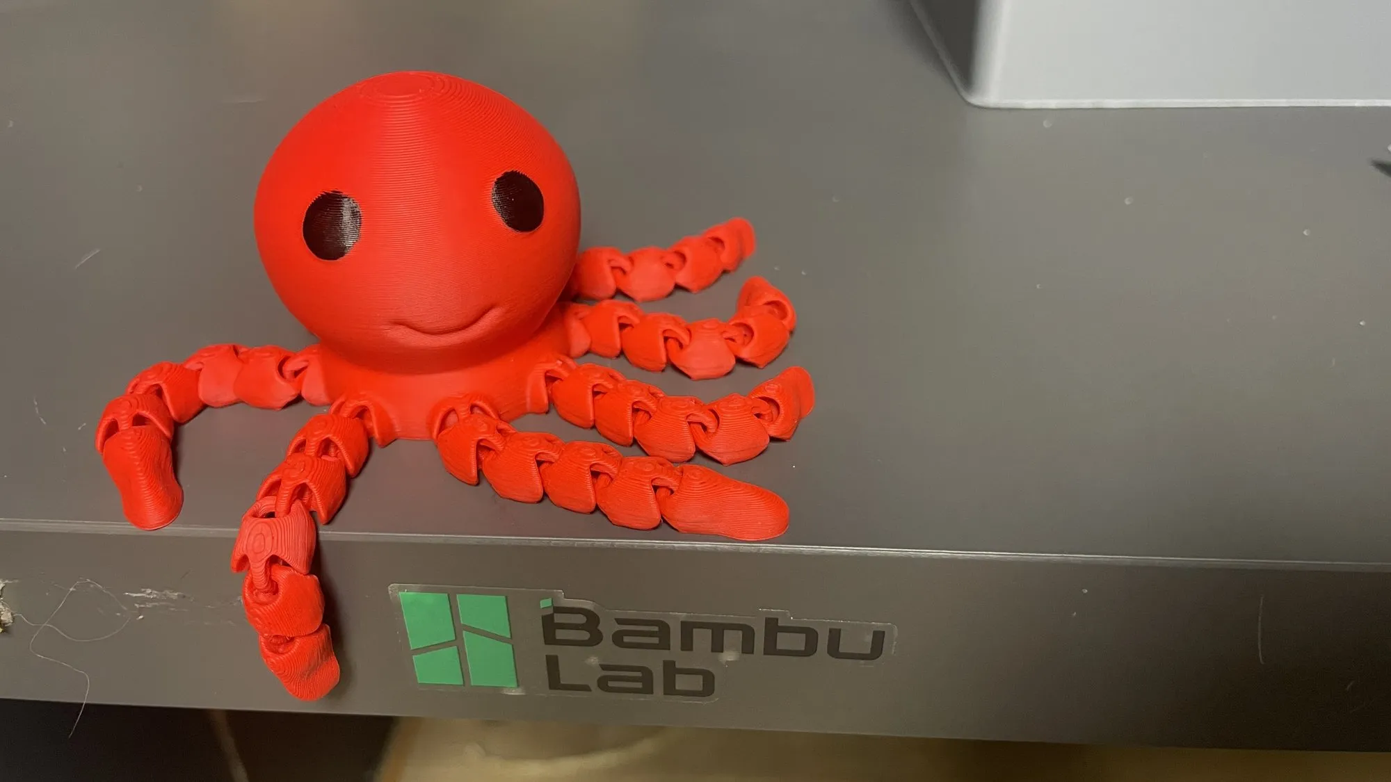 A red flexi octopus print on the printer